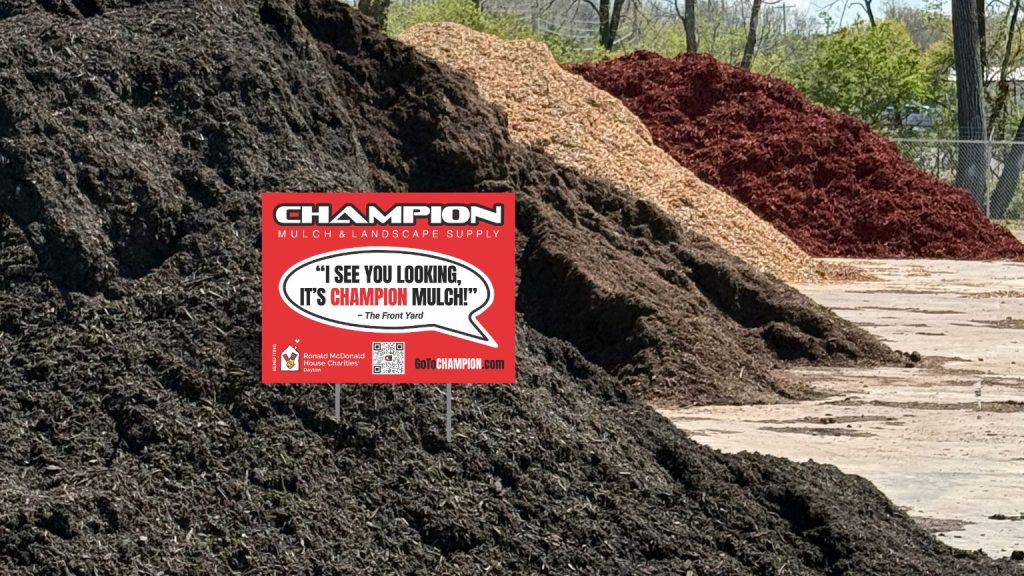 Champion Mulch yard sign promoting the 2026 partnership with Ronald McDonald House Charities Dayton, displayed in front of mulch piles.
