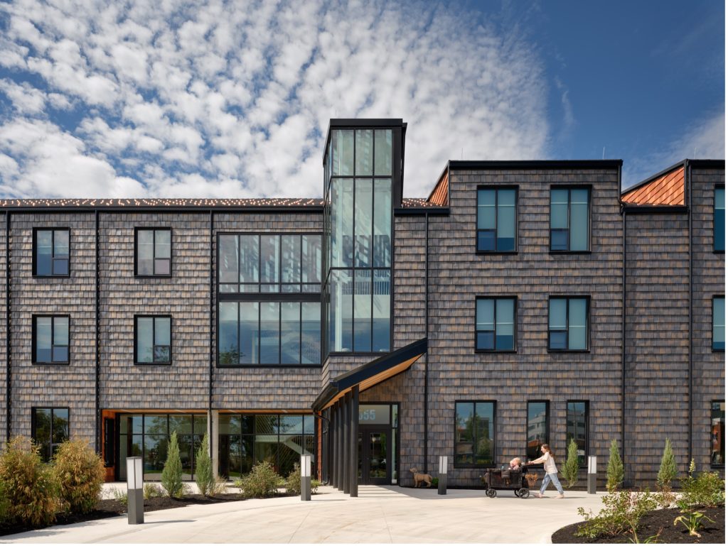 Exterior view of the Ronald McDonald House at 555 Valley Street in Dayton, a three-story building with large windows located across from Dayton Children's Hospital.