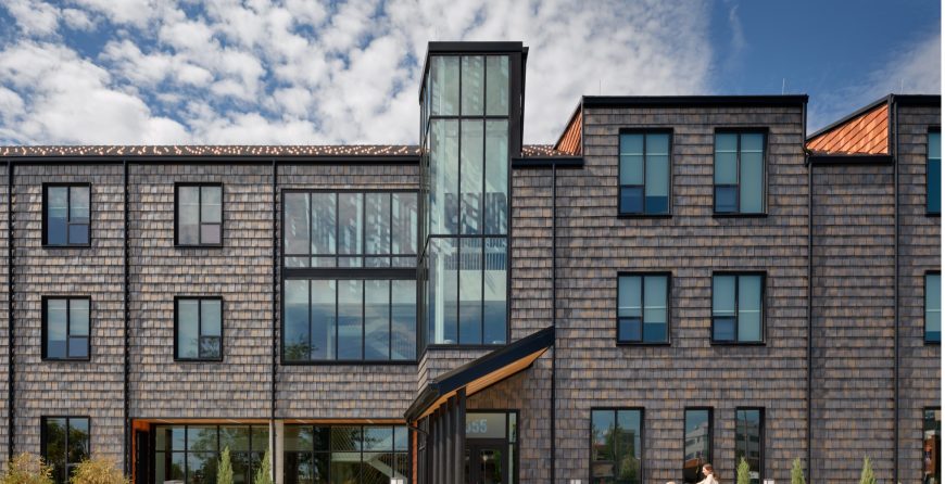 Exterior view of the Ronald McDonald House at 555 Valley Street in Dayton, a three-story building with large windows located across from Dayton Children's Hospital.