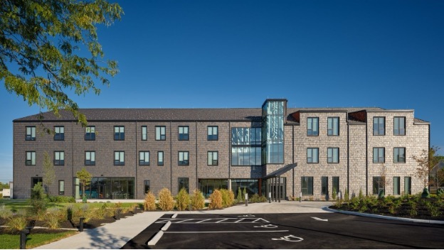 555 Valley Street, a multi-story brick-and-stone facility with large windows and a covered entrance.